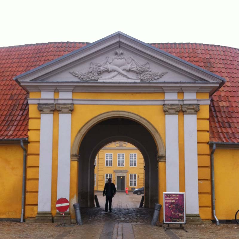 Consultancy-Migration-Cover-Hamide-Design-Studio Entrance of Museet for Samtidskunst Roskilde with the event poster of "Study Group on Migration Presents"