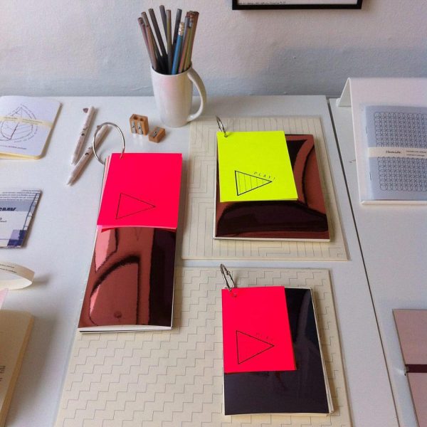 A couple of showing the different pages of "Play!" notebooks