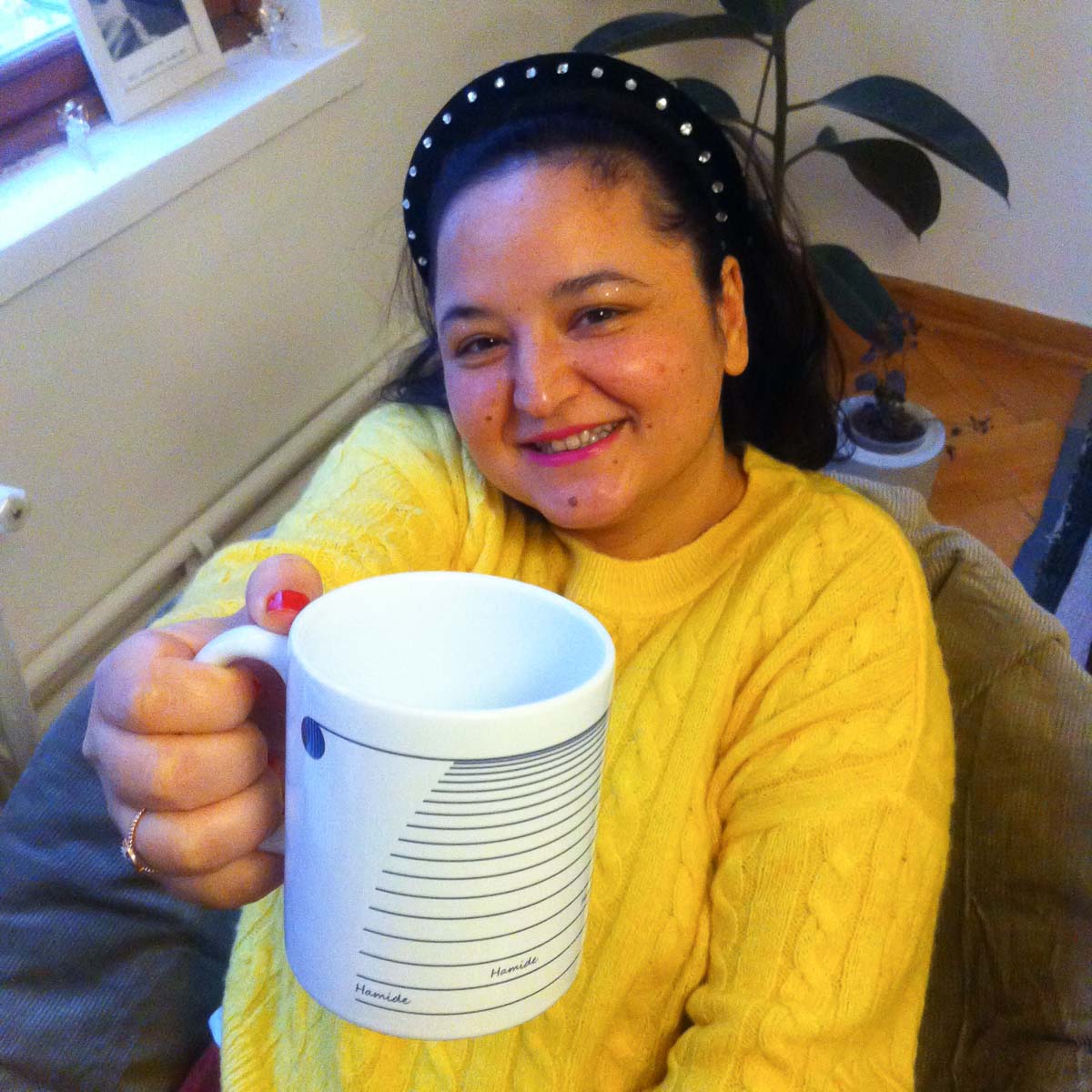 Blog-Officially-Seven-Holding-Coffee-Mug-Hamide-Design-Studio Seda holding the 7th year coffee mug
