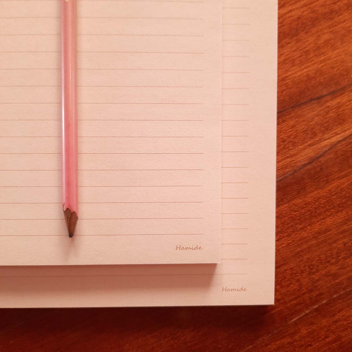 Collections-Basics-Notepads-Editorial-Light-Peach-Brand-Hamide-Design-Studio Close-up image of light peach Hamide Basics notepads