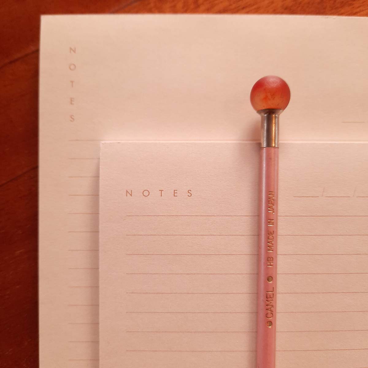 Collections-Basics-Notepads-Editorial-Light-Peach-Heading-Hamide-Design-Studio Close-up image of light peach Hamide Basics notepads