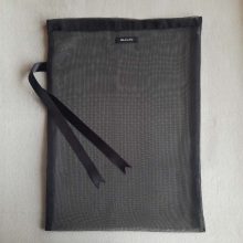 Back of large reusable tulle sac in black for shopping groceries