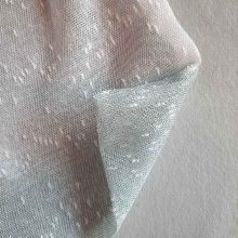 Texture of large reusable tulle sac in gradient green for shopping groceries
