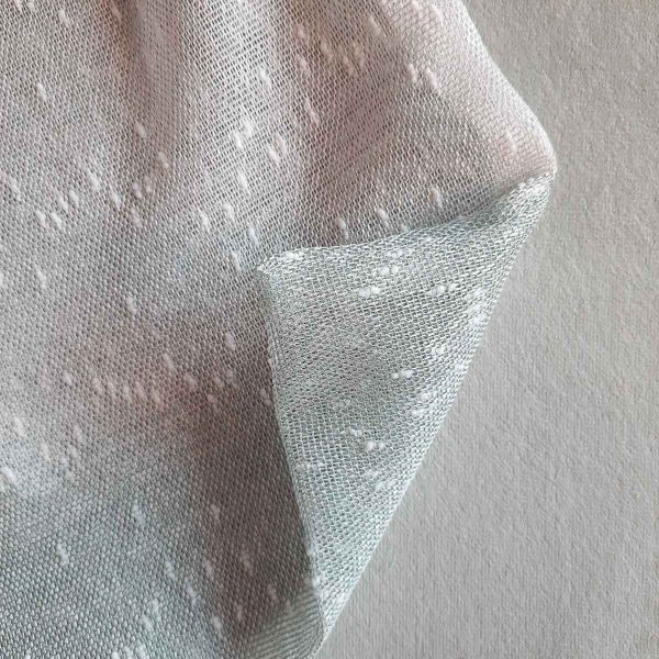 Texture of large reusable tulle sac in gradient green for shopping groceries
