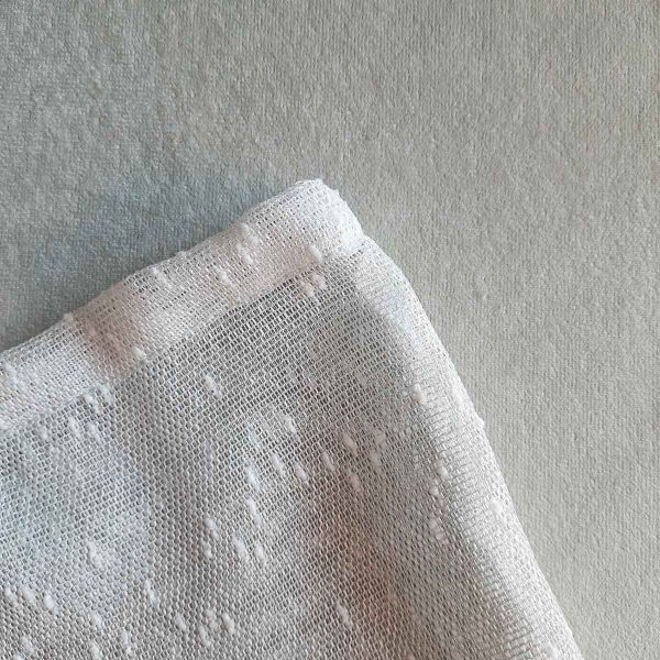 Texture of large reusable tulle sac in gradient green for shopping groceries