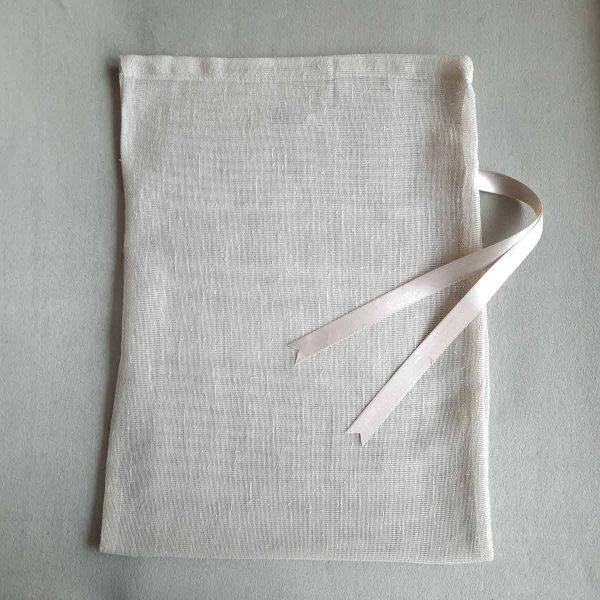 Front of large reusable tulle sac in cream for shopping groceries