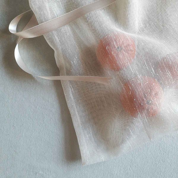 Texture of large reusable tulle sac in cream for shopping groceries