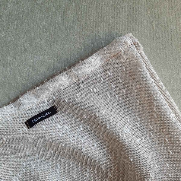 Texture of large reusable tulle sac in gradient brown for shopping groceries