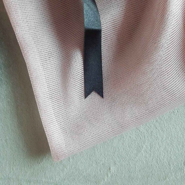 Texture of large reusable tulle sac in pink for shopping groceries