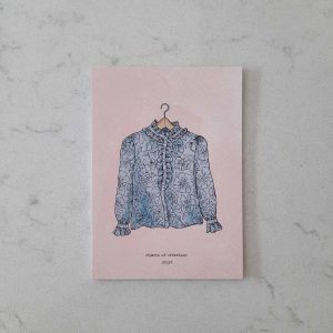 Postcard featuring a handmade shirt designed and made by our honorary founder and mother Hamide